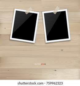 Blank photo frame or picture frame stick on wooden wall background. Vector illustration.