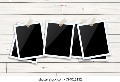 Blank photo frame or picture frame stick on white wooden wall. Vector vintage background.