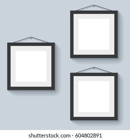 Blank photo frames hanging on the wall vector illustration.