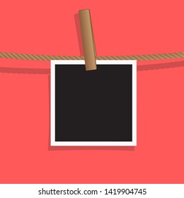 A Blank Photo Frames on Pastel Red Color Background and Clothespin Line Up Hemp Rope