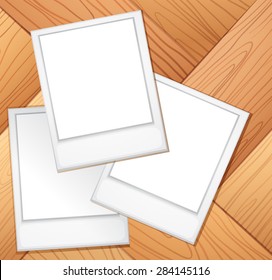 Blank photo frames on the wooden background