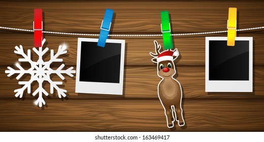 Blank photo frames, reindeer and snowflake on a clothesline. Vector illustration.