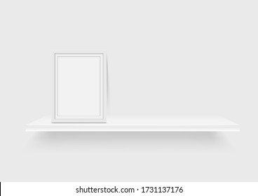 Blank picture frame and white shelf isolated on gray background
