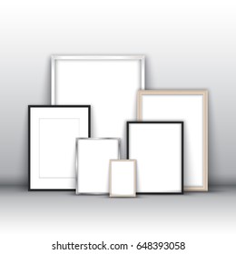 Blank picture frames leaning against a wall