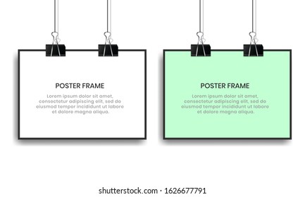 Blank posters hanging with binder clips.