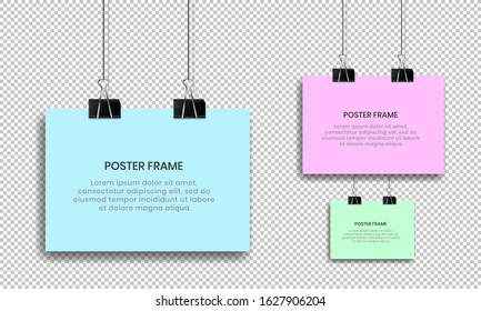 Blank posters hanging with binder clips.