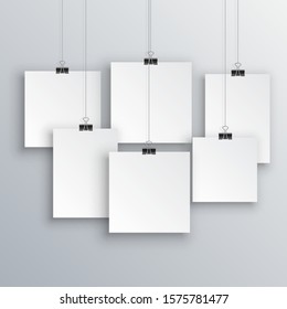 Blank posters hanging with shadows. Hanging white paper on binders. A4 paper page, mockup, sheet on wall - vector