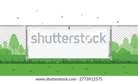 A blank rectangular white vinyl banner is securely fastened with metal grommets onto a grey chain-link fence in an outdoor park setting with lush green foliage.