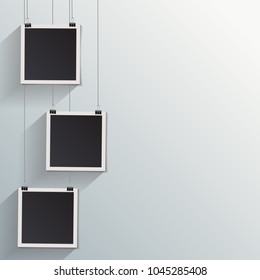 Blank retro vintage photo frames on a wall.