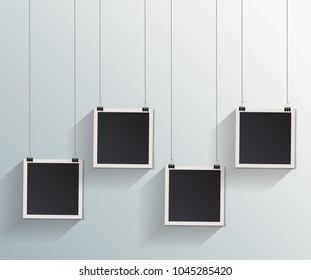 Blank retro vintage photo frames on a wall.