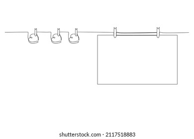 Blank sheet hangs on a rope with clothespins with hearts. Festive background. Layout or template for a holiday card. Vector illustration. Single continuous line drawing.
