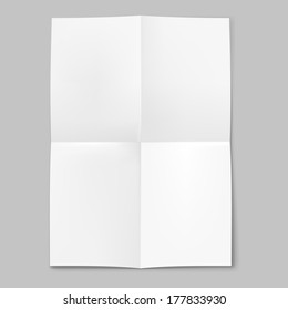 Blank sheet of paper folded in four on grey background