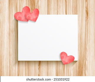 Blank sheet of paper with hearts on wood texture background