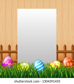 Blank sign in the grass field with decorated Easter eggs