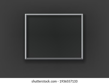 Blank silver frame on a black wall. Template for a text