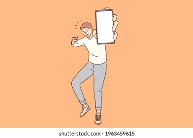 Blank space, smartphone technology concept. Young smiling man cartoon character standing holding mobile phone with blank white screen in hands over orange background vector illustration 