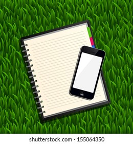 Blank spiral notepad notebook and smart phone on green grass background - Vector illustration