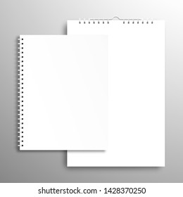 Blank white closed book or notebook with a spiral and calendar or poster. Top view mockup template with shadow