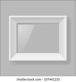 Blank white frame hanging on gray wall