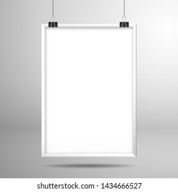 Blank white frame hanging on the clips above the surface. Mockup for design with shadow