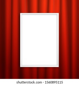 Blank white frame for an image or poster hanging near the red curtain. Mockup for design