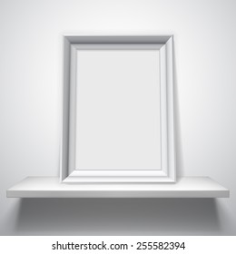 Blank white picture frame on white shelf