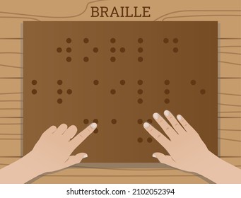 A blind person reading on a braille board on a wooden table