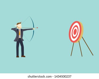 Blindfolded businessman shooting arrow,business character concept