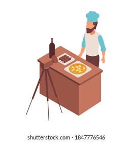 Blogger isometric composition with character of cook in uniform with food on table and camera vector illustration