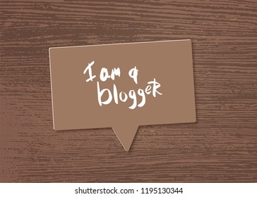 I am a blogger quote with speech bubble and wood background. Hand lettering phrase for social media networks. Vector illustration.