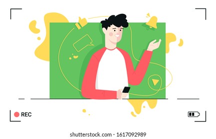 Blogger recording video holding smartphone with notes on green screen. Smiling vlogger in camera frame view.