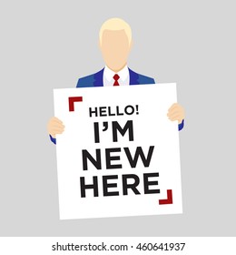 Blond man in suit holding Hello I'm New Here Sign