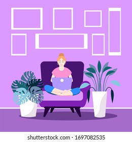 Blonde girl sitting with laptop on sofa. Young woman working on the computer, studying, browsing internet, chatting, blogging. Social distancing during coronavirus (COVID-19) pandemic. Stay home