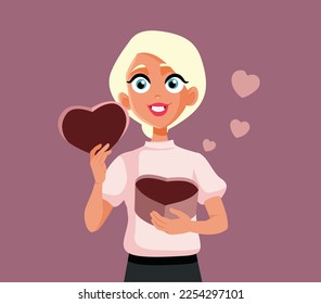 
Blonde Woman Holding a Heart Shape Gift Box Vector Illustration. Pretty girlfriend receiving a Valentine’s gift from her boyfriend
