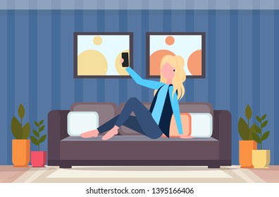 blonde woman sitting on couch girl taking selfie photo on smartphone camera modern living room interior female cartoon character flat full length horizontal