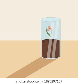 Blooming flower with leaf and soil in glass cylinder. Shadow falling on the table.