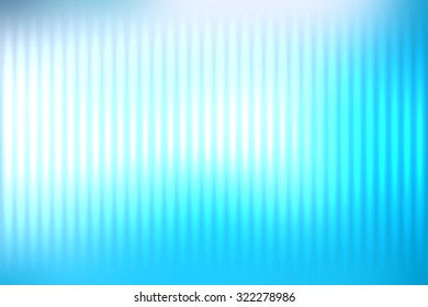 Blue abstract blur colored background with defocused vertical rays of light.