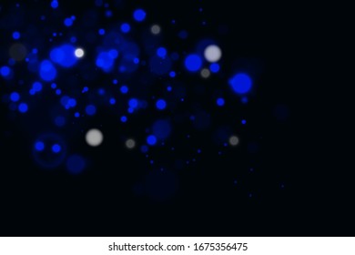 Fondo de bokeh azul abstracto. partículas de polvo reales con retroiluminación con una lente flash real. Luces abstractas del festival pegadas. Navidad navideña y Año Nuevo.