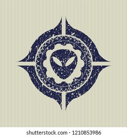 Blue alien icon inside distressed rubber grunge stamp