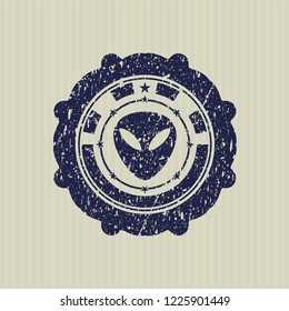 Blue alien icon inside distressed rubber seal
