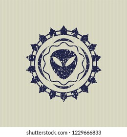 Blue alien icon inside rubber seal with grunge texture