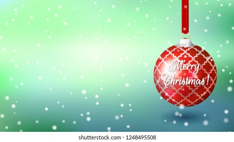 Blue background with a large red Christmas ball and the inscription Merry Christmas. Wide screen
