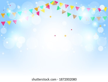 Blue background and multicolored flags with white bokeh for Christmas and New Year.