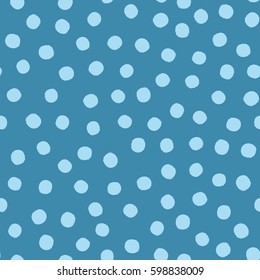 Blue background with scattered round spots. Seamless pattern with dots painted rough brush. Vector illustration.