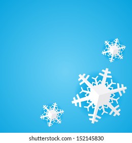 Blue background with white paper christmas snowflake with shadow