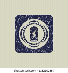 Blue battery charging icon inside distress rubber seal with grunge texture