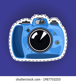 Blue beautiful cute instant print camera , manual camera on a purple violet pop art halftone background, black dots in the form of a circle , pins or patches, retro style, vector illustration