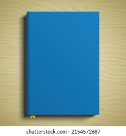 Blue book cover 3D vector mockup. A closed paperback book lying on a wooden table surface.