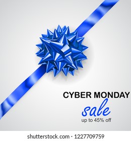 Blue bow with diagonally ribbon with shadow and inscription Cyber Monday Sale on white background