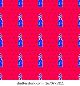 Blue Burning candle icon isolated seamless pattern on red background. Cylindrical candle stick with burning flame.  Vector Illustration